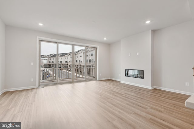 unfurnished living room with light hardwood / wood-style floors