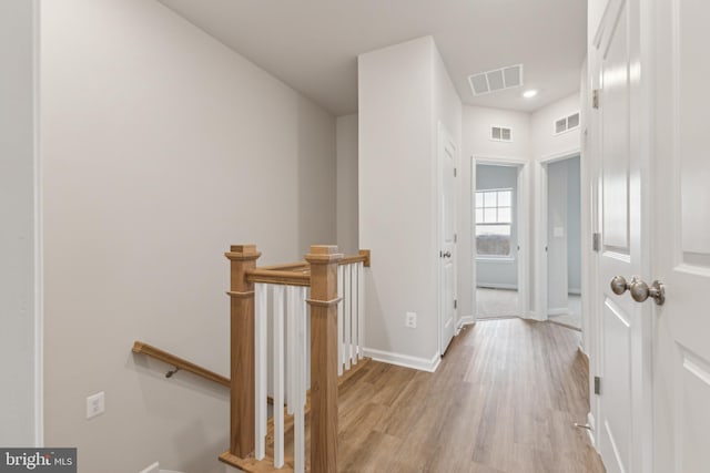 hallway with light hardwood / wood-style floors