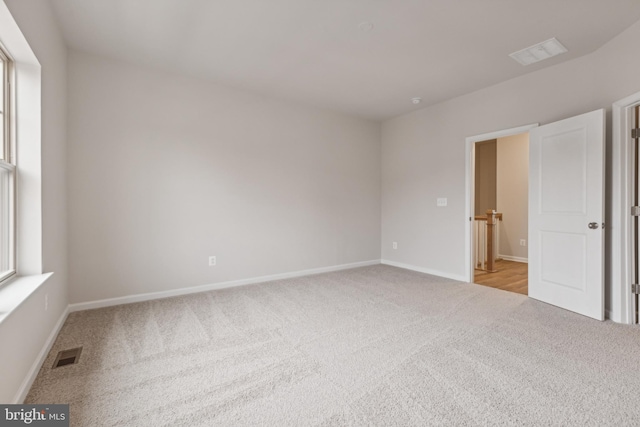 unfurnished room with light colored carpet