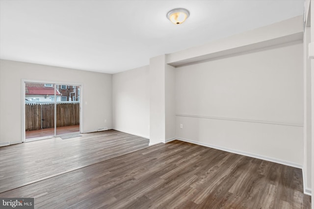 empty room with hardwood / wood-style floors