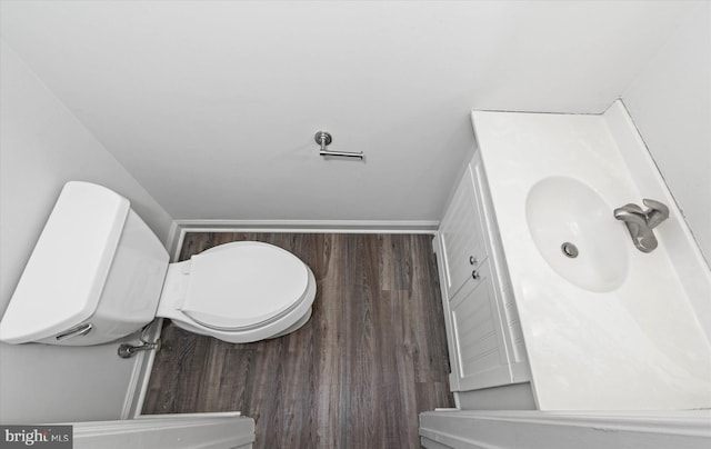 bathroom featuring vanity, hardwood / wood-style flooring, and toilet