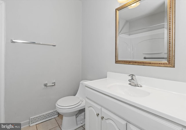 bathroom with tile patterned flooring, vanity, and toilet