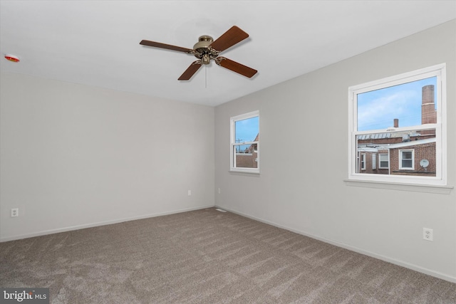 carpeted empty room with ceiling fan