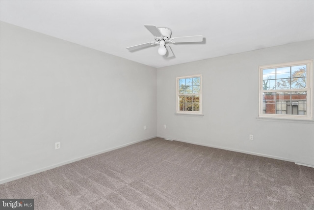 empty room featuring ceiling fan and carpet floors