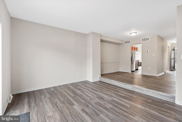 spare room with wood-type flooring