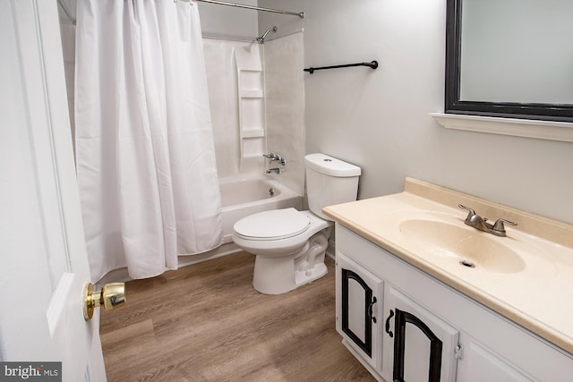 full bathroom with hardwood / wood-style flooring, shower / bath combination with curtain, toilet, and vanity