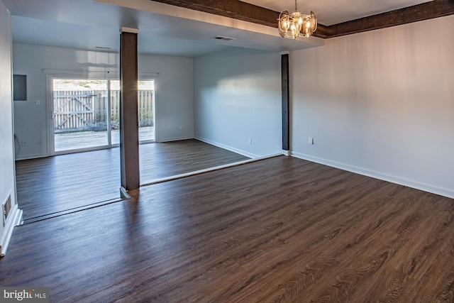 spare room with a chandelier, dark hardwood / wood-style floors, and beamed ceiling