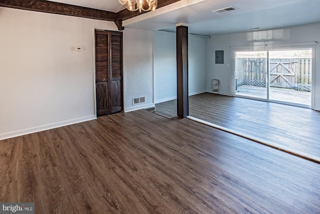 empty room featuring hardwood / wood-style floors and beam ceiling