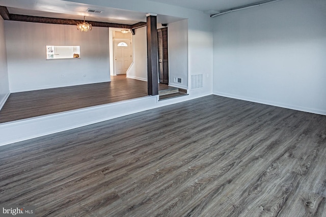 basement with dark hardwood / wood-style floors and a chandelier