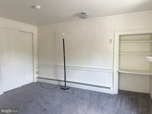 unfurnished bedroom with dark colored carpet, ornamental molding, a closet, and a baseboard heating unit