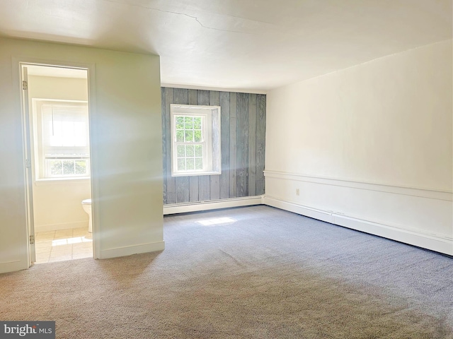 carpeted spare room with a baseboard radiator