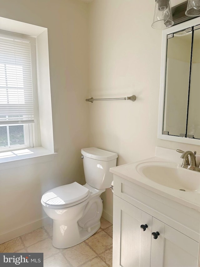 bathroom with tile patterned floors, vanity, and toilet