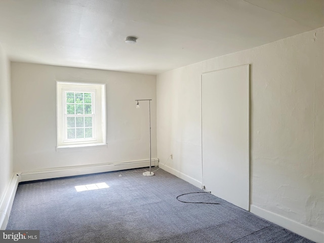 carpeted empty room with a baseboard radiator