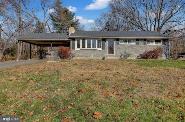 ranch-style home with a front lawn and a carport