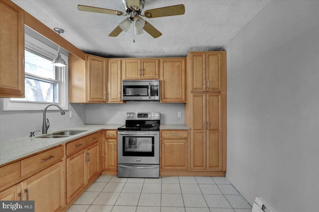 kitchen featuring appliances with stainless steel finishes, a textured ceiling, a baseboard heating unit, and sink