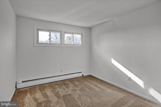 carpeted spare room featuring baseboard heating