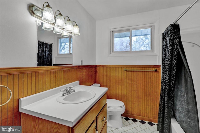 full bathroom featuring tile patterned floors, wood walls, and a healthy amount of sunlight