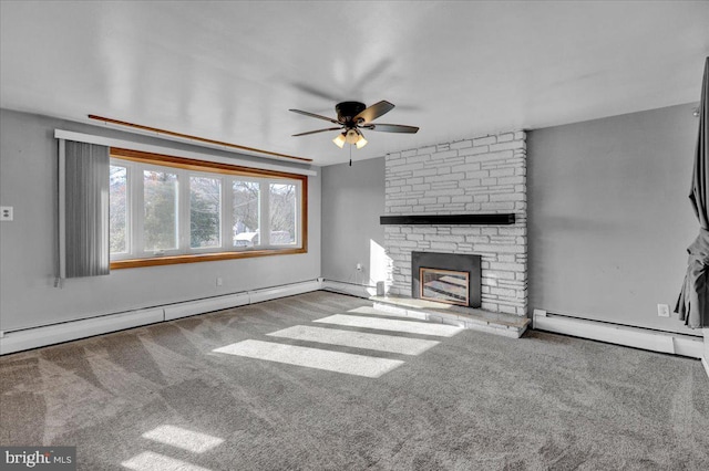 unfurnished living room featuring baseboard heating, a stone fireplace, and carpet flooring