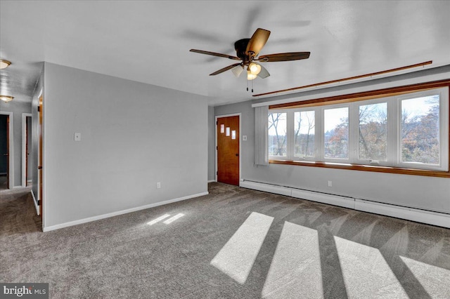 interior space with carpet flooring, ceiling fan, and a baseboard heating unit