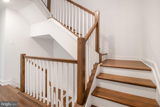 stairs featuring hardwood / wood-style flooring