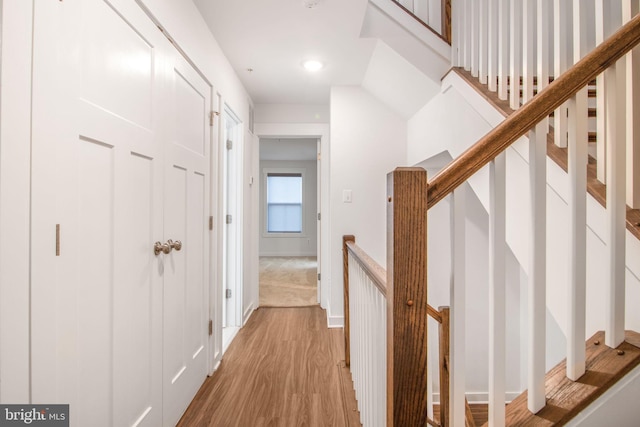 corridor with light hardwood / wood-style flooring