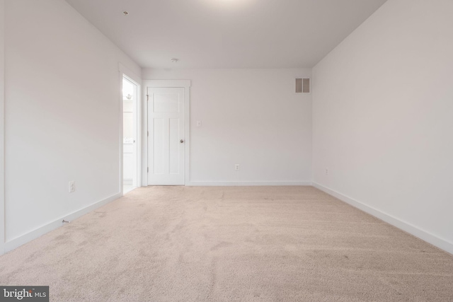 empty room featuring light colored carpet