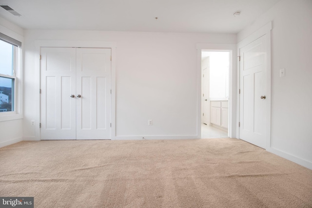 unfurnished bedroom with light carpet