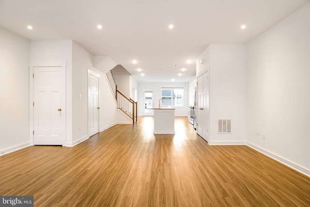 unfurnished living room with light wood-type flooring