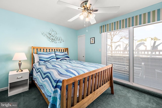 bedroom featuring dark colored carpet, ceiling fan, and a closet