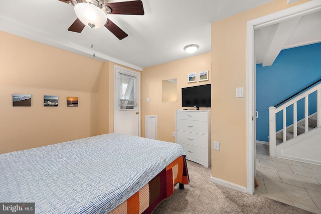 bedroom featuring ceiling fan and light carpet