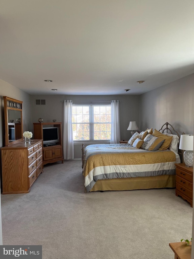 bedroom with light colored carpet