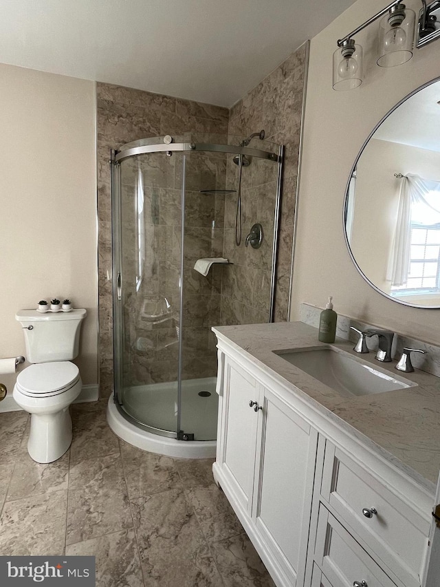 bathroom with vanity, toilet, and an enclosed shower