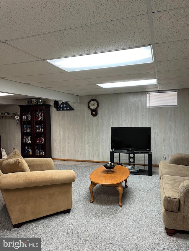 carpeted living room featuring a paneled ceiling