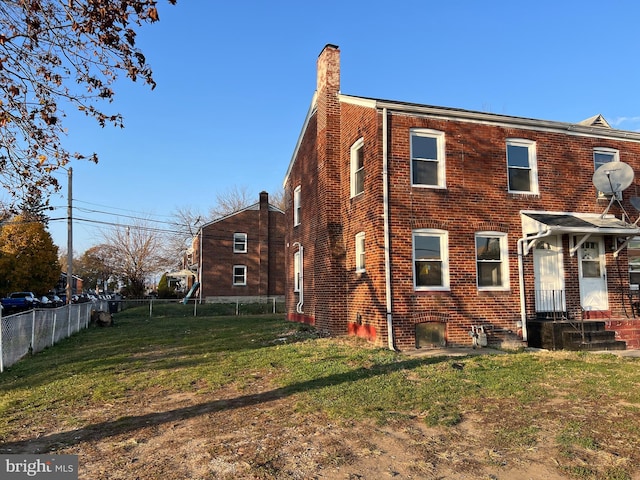 rear view of house featuring a lawn