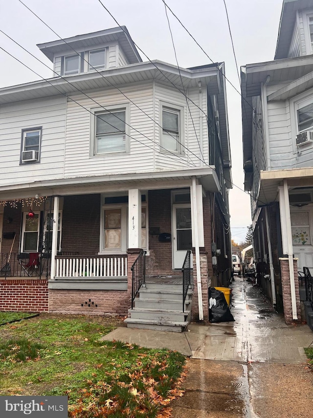 view of front of home featuring cooling unit and a porch