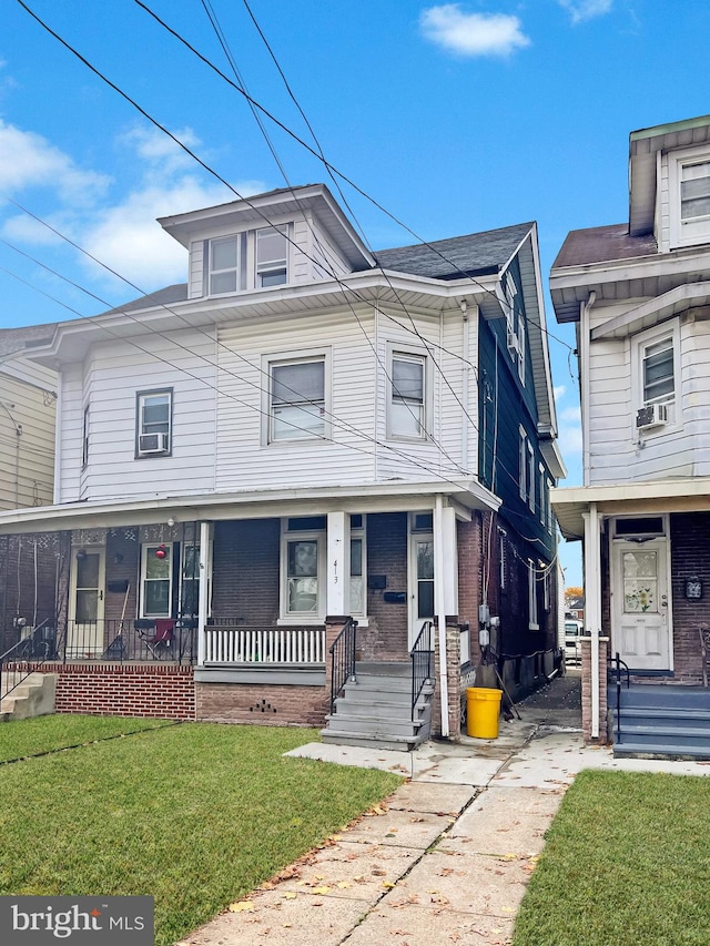 view of front of property featuring a front lawn and cooling unit