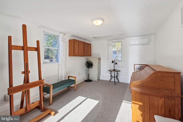 sitting room featuring plenty of natural light, carpet, and a wall mounted air conditioner