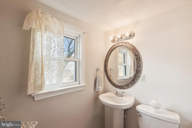 bathroom featuring plenty of natural light and toilet