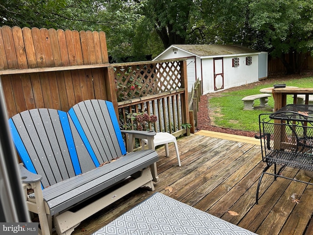 wooden terrace featuring a storage shed