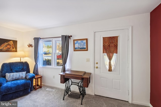 view of carpeted foyer entrance