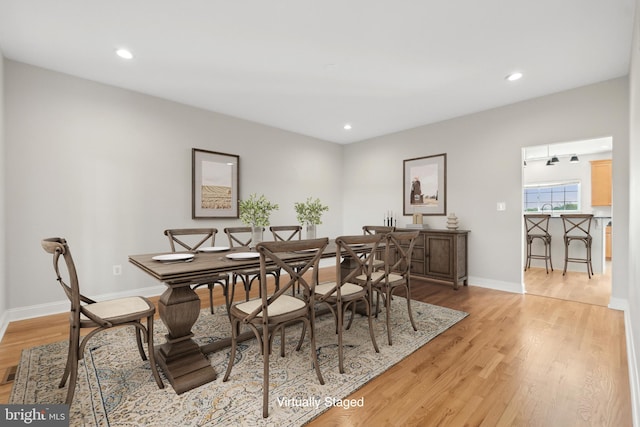 dining room featuring light wood-style floors, recessed lighting, and baseboards