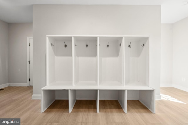 mudroom featuring baseboards and light wood-style flooring