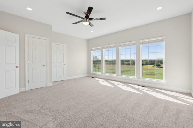 unfurnished bedroom featuring recessed lighting, baseboards, a ceiling fan, and carpet