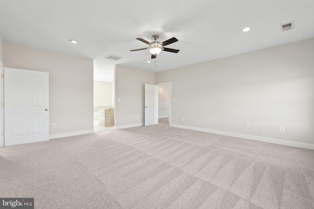 empty room featuring visible vents, baseboards, ceiling fan, and light carpet