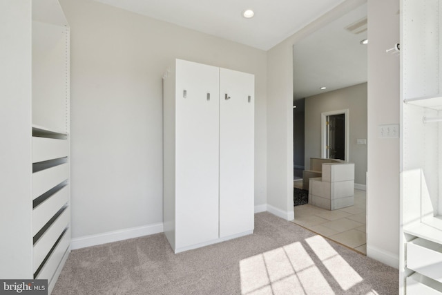 unfurnished bedroom featuring carpet floors, recessed lighting, and baseboards