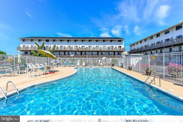 view of swimming pool featuring a patio area