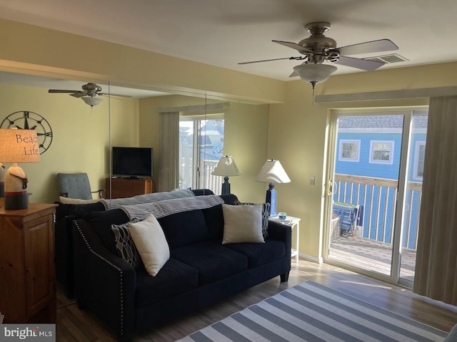 living room with hardwood / wood-style flooring and ceiling fan