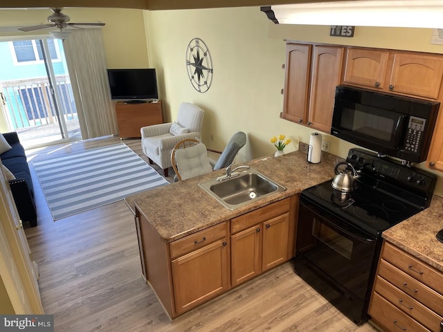 kitchen featuring black appliances, ceiling fan, light hardwood / wood-style floors, and sink