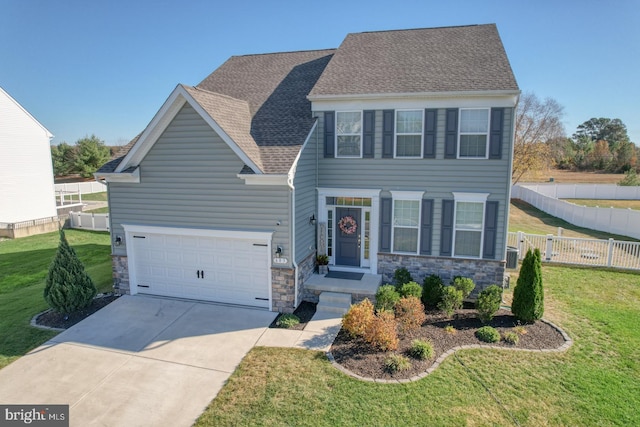 view of front of home with a garage and a front yard