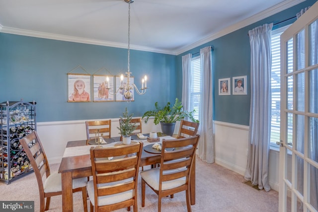 carpeted dining area with crown molding, plenty of natural light, and a notable chandelier